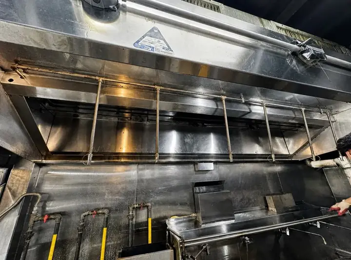 Commercial kitchen hood opened for maintenance service
