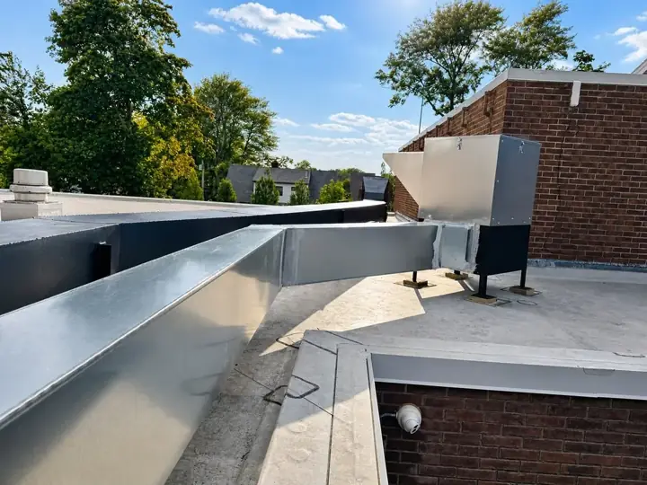 Finished rooftop metal ductwork connected to ventilation equipment